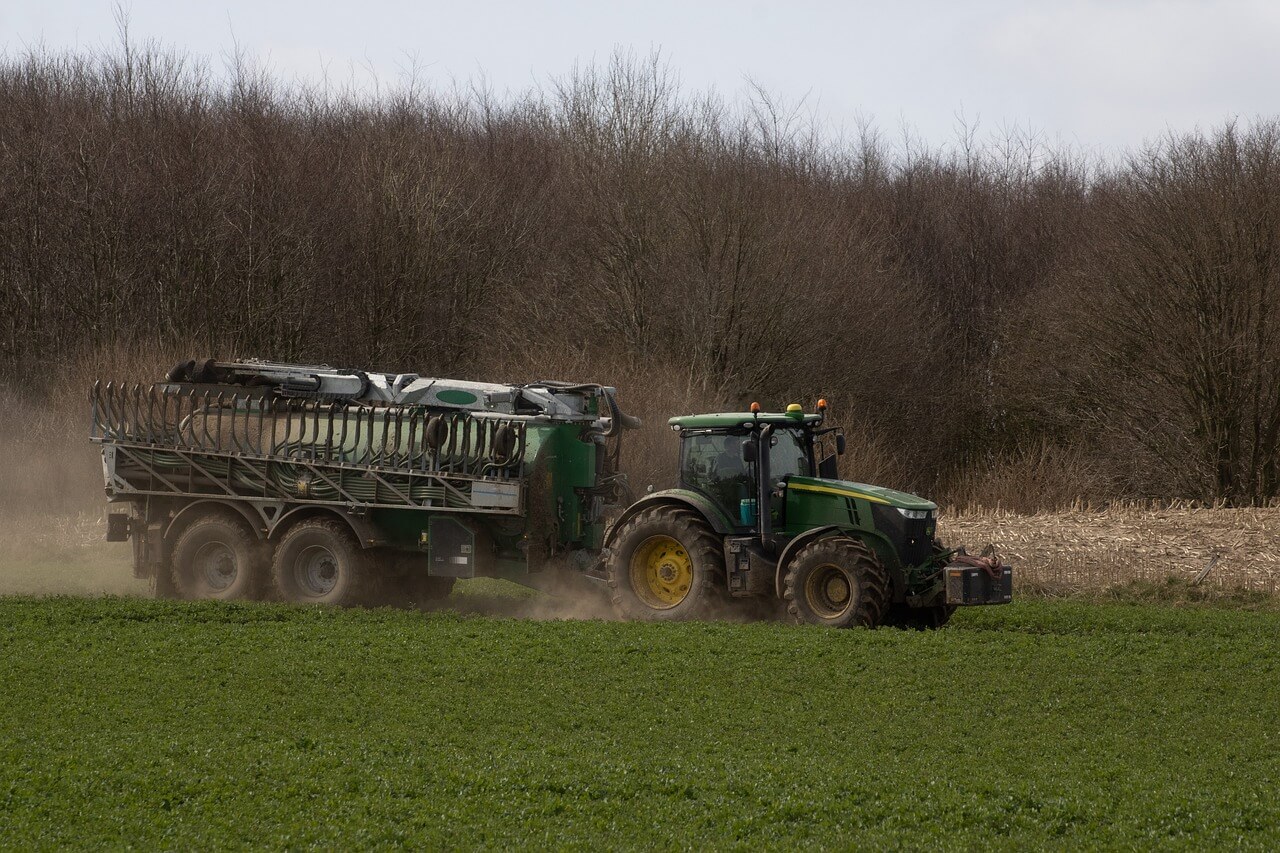 combine harvester plows land fertilized with biochar